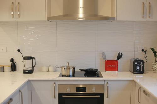 un comptoir de cuisine avec une cuisinière et un mixeur dans l'établissement Cozy and comfortable, sunny three-storey building, à Auckland