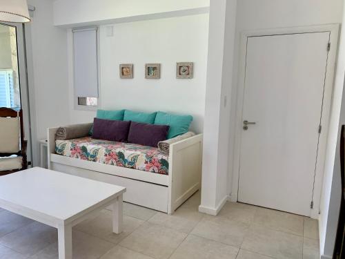 a living room with a couch and a table at Departamento Quequen Chico in Quequén