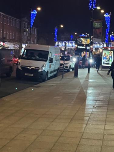 a city street at night with cars parked at TJ Homes - One double bed room with garden view - Next to tube station in Ruislip