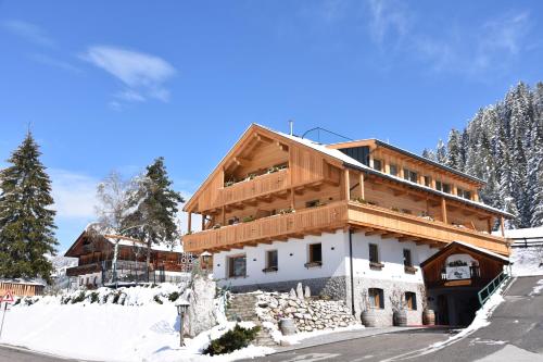 a house is being built in the snow at Hotel Rosengarten in Dobbiaco
