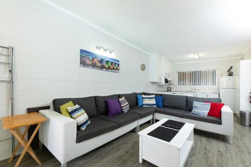 a living room with a couch and a table at Forster Lodge 8 in Forster