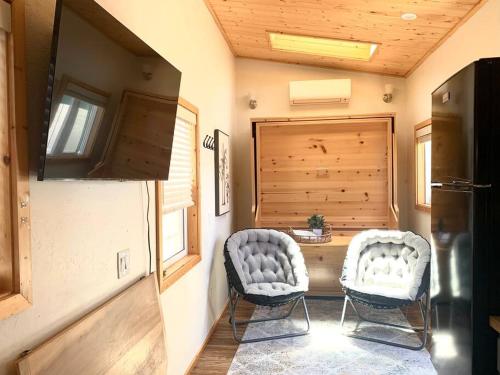 a room with two chairs and a table in a house at Sunshine Tiny Studio and Loft Close to Downtown in San Luis Obispo