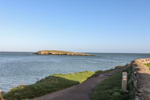 an island in the middle of a body of water at Haulfryn in Moelfre
