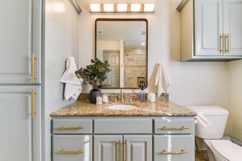 a bathroom with a sink and a mirror at Cozy 3 bed 2 bath Cottage Near Nichols Hills in Oklahoma City