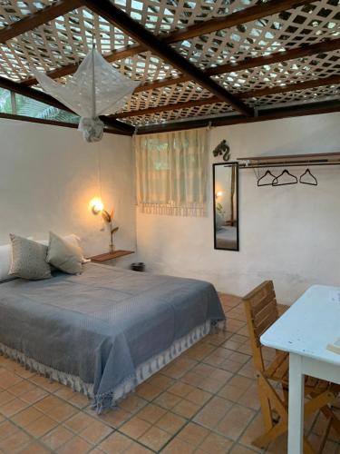 a bedroom with a bed with a wooden ceiling at Oka Hey, Sayulita in Sayulita