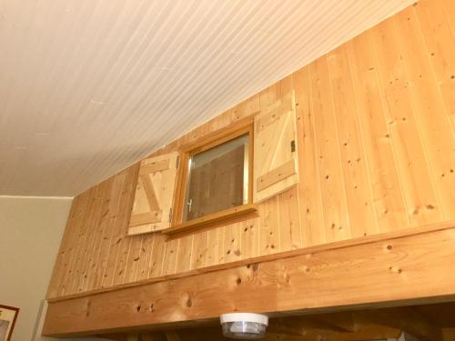 a wooden wall with a window in a room at ∞ Hyper centre ∞ La marmotte ∞ petit T2 ∞ entrée24h/24 ∞ près ski/cure ≈AX-LES-THERMES≈ wifi ∞ in Ax-les-Thermes