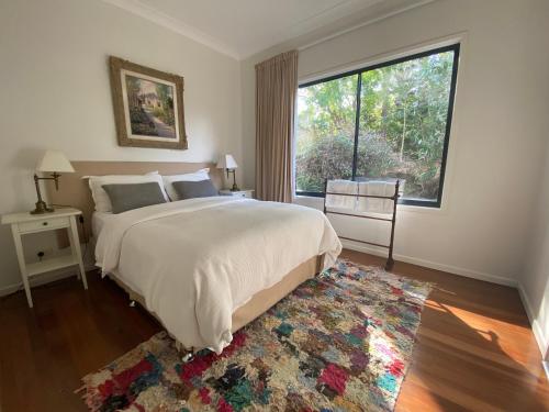 a bedroom with a large bed and a large window at Balmoral 575 in Montville