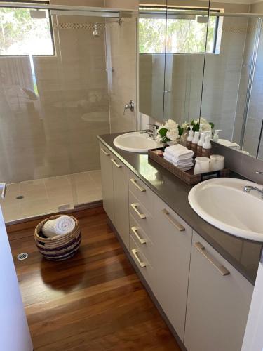 a bathroom with two sinks and a shower at Balmoral 575 in Montville