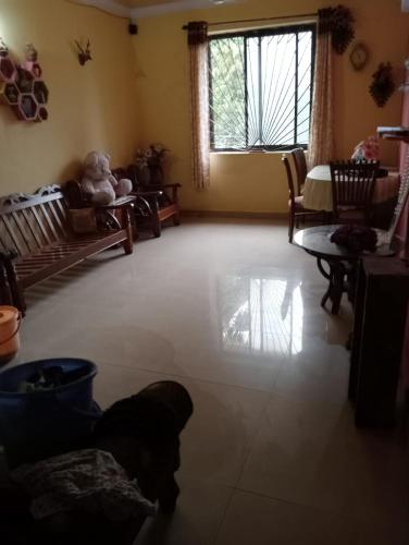 a living room with a teddy bear sitting on a couch at LUXURY 1 bedroom flat in Madgaon