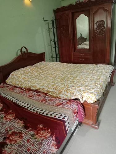 a bedroom with a bed with a dresser and a mirror at LUXURY 1 bedroom flat in Madgaon