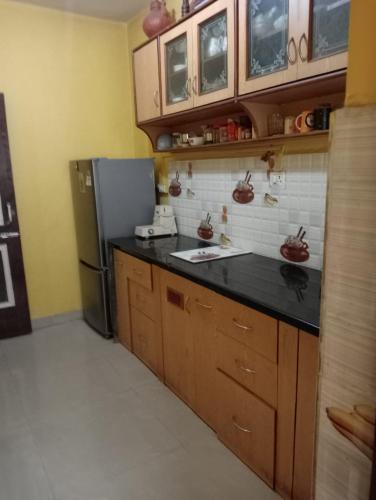 a kitchen with a sink and a refrigerator at LUXURY 1 bedroom flat in Madgaon