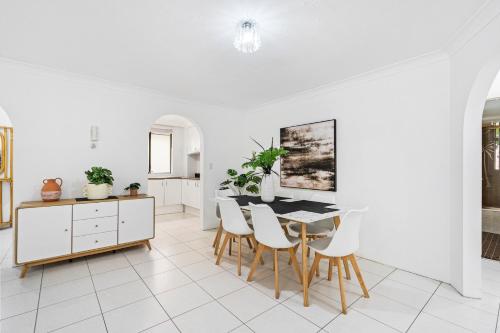 a kitchen and dining room with a table and chairs at Coco Bella Dream in Surfers Paradise in Gold Coast