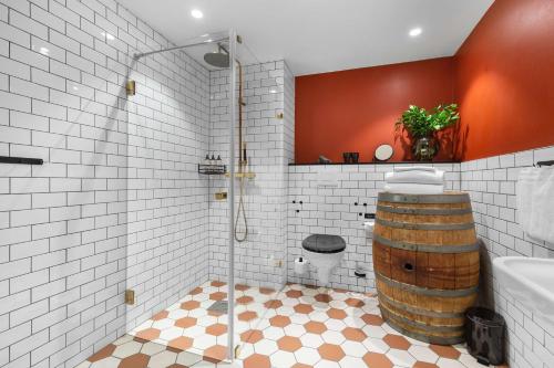 a bathroom with a barrel shower and a toilet at The Winery Hotel, WorldHotels Crafted in Solna