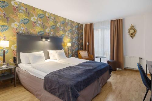 Best Western Plus Hotel Noble House tesisinde bir odada yatak veya yataklar