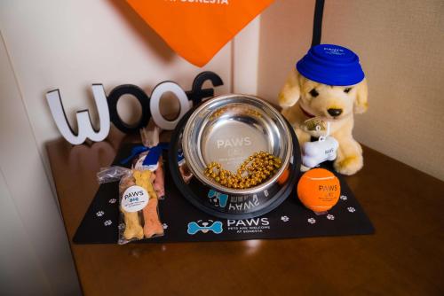 a stuffed bear sitting next to a bowl of dog food at Sonesta Simply Suites Pittsburgh Airport in Imperial