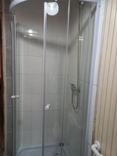 a shower with a glass door in a bathroom at Hostal CKAIR in Bahia Inglesa