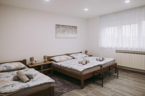 a room with two beds in a room with at Tamaris in Vukovar