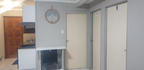 a kitchen with white cabinets and a sink at Georgina Self-Catering Flat in George