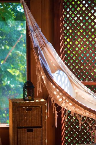 a hammock hanging from a wall next to a window at Manicou River Resort in Portsmouth