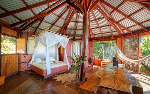 a bedroom with a bed and a hammock in a room at Manicou River Resort in Portsmouth