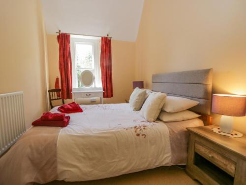 a bedroom with a large bed and a window at Millwood Manor in Barrow in Furness