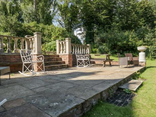 a patio with chairs and a staircase in a park at Millwood Manor in Barrow in Furness