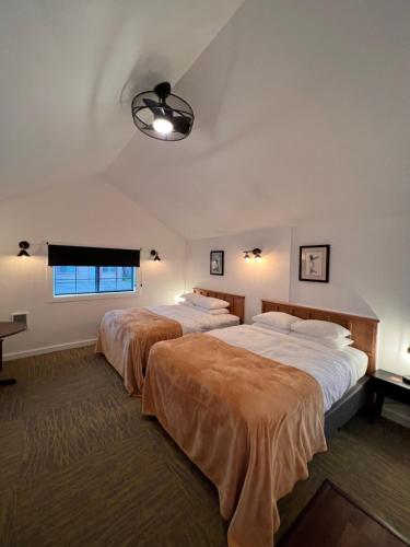 a bedroom with two beds and a window at The Seaview Cottages in Seaview