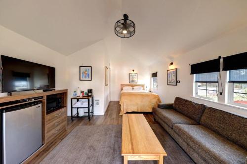 a living room with a couch and a bed at The Seaview Cottages in Seaview