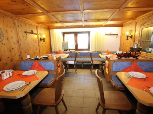 a dining room with wooden walls and wooden tables and chairs at Bergheimat L in Winkle