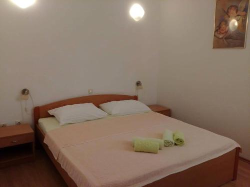 a bedroom with a bed with two towels on it at Apartment Kornic 5306b in Kornić