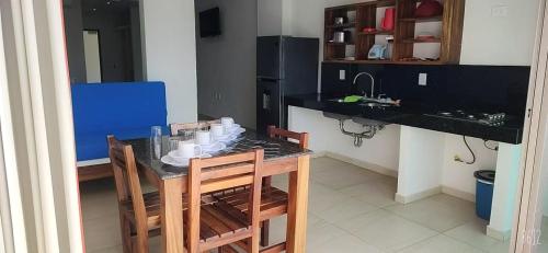 a kitchen with a table and two chairs and a counter at MALAKI in Los Ayala