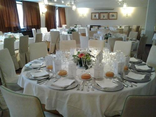a table set up for a wedding with white tables and chairs at Parador de Gredos in Navarredonda de Gredos