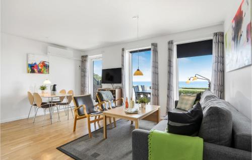 a living room with a couch and a table at 1 Bedroom Amazing Apartment In Allinge in Allinge