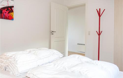 a white bedroom with two white pillows on a bed at 1 Bedroom Amazing Apartment In Allinge in Allinge