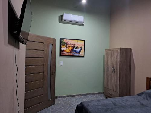 a bedroom with a bed and a dresser and a window at Pousada Rio e Mar in Fortim
