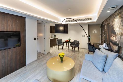 a living room with a couch and a table at Almond Business Hotel in Nicosia