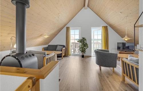 a living room with a wood stove in a room at Awesome Home In Gråsten With Sauna in Gråsten