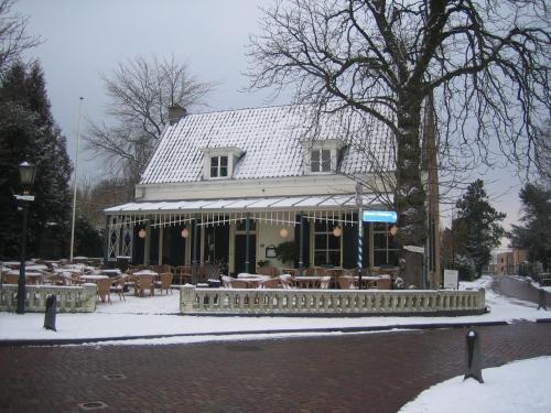 a restaurant with tables and chairs in the snow at Restaurant Hotel Buitenlust in Amerongen