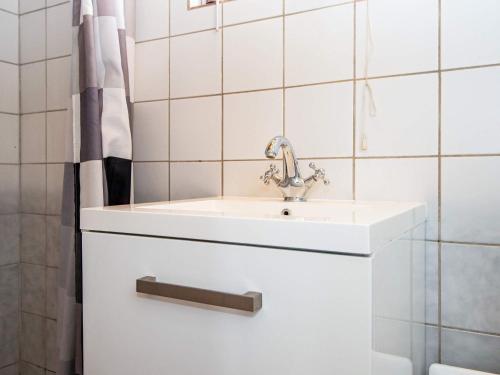 a white bathroom with a sink and a shower at 4 person holiday home in Aabenraa-By Traum in Aabenraa