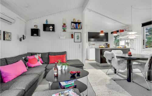 a living room with a couch and a table at Cozy Home In Ålbæk With Wifi in Ålbæk