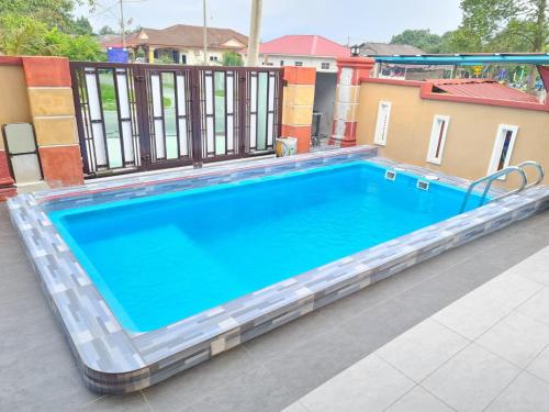 a large blue swimming pool on a balcony at HOMESTAY EPOH MANJOI WITH PRIVATE POOL AND JACUZZI in Ipoh