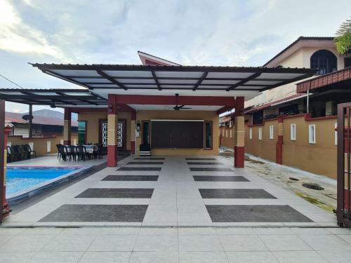 a patio of a house with a pool at HOMESTAY EPOH MANJOI WITH PRIVATE POOL AND JACUZZI in Ipoh