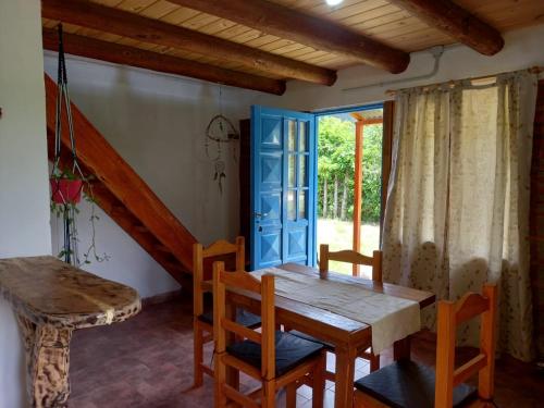 a dining room with a wooden table and chairs at Duplex Luna in Lago Puelo