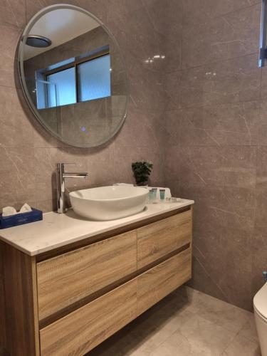 a bathroom with a sink and a mirror at Nagambie Motor Inn and Conference Centre in Nagambie