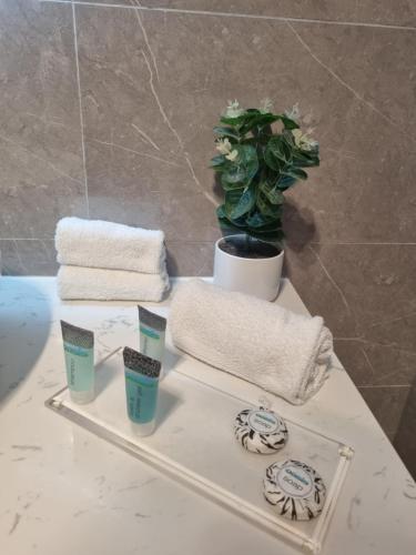 a white table with towels and a plant on it at Nagambie Motor Inn and Conference Centre in Nagambie