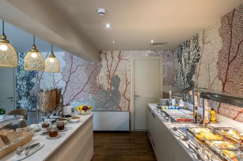 a kitchen with a buffet line with food at Almond Business Hotel in Nicosia