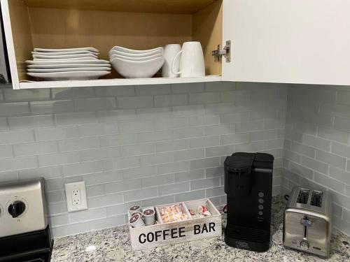 a cupboard filled with dishes and a coffee bar at Modern 2/1 in Parrish FL Sleeps 6 Quiet Dead End St 1/2 Acre Wow in Parrish