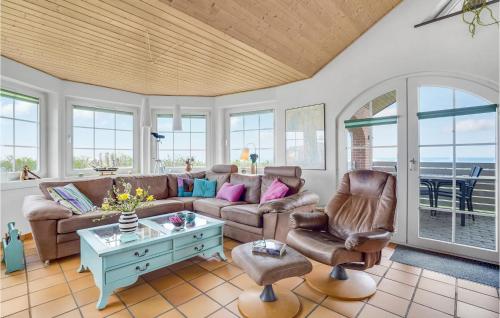 a living room with a couch and chairs at Awesome Home In Lemvig With Kitchen in Lemvig