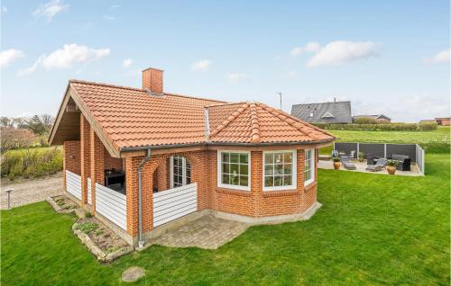 a small brick house on a green lawn at Awesome Home In Lemvig With Kitchen in Lemvig