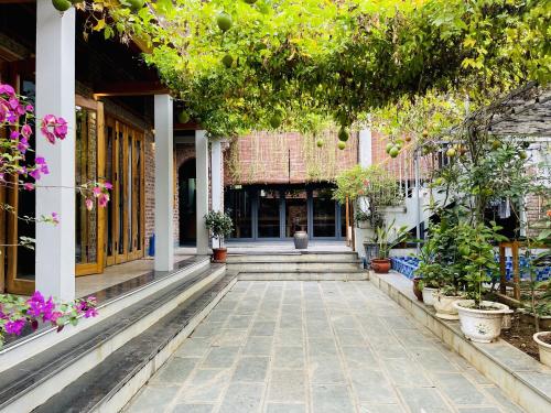 a courtyard of a building with plants and flowers at Đường Lâm homestay - House Number 9 in Sơn Tây